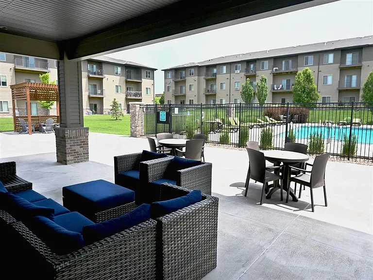 Community outdoor lounge area next to pool at The Sterling Kearney.