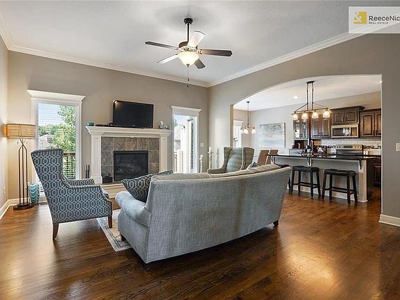 Continue into the open concept living room/kitchen/dining space. The oversized windows really make this space feel inviting.