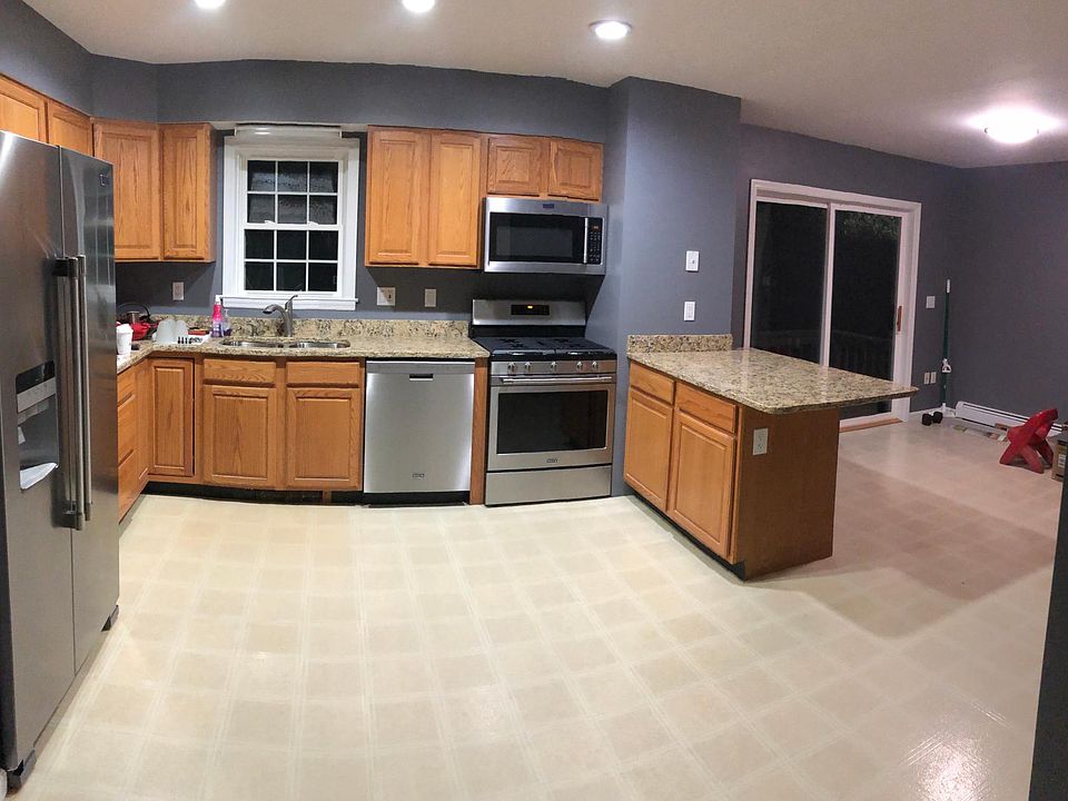 Large kitchen with brand new appliances and granite countertops. Sliding glass door exits to small deck off of the eat in kitchen.