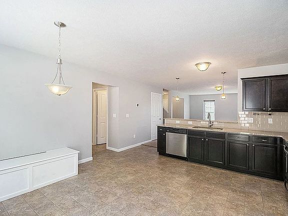 Large kitchen with room for dining table along built-in wall bench (plus storage)