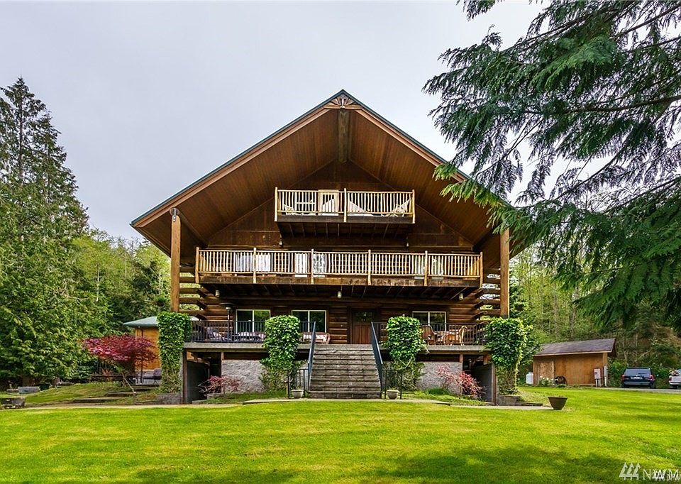 Welcome to 1947 Beverly Beach Rd in Freeland. This stately, warm and inviting log home is perfectly nestled on 7 acres and features 5528 sq feet, 4 bedrooms, 5.75 baths and several bonus rooms with 2 additional kitchens. Premium Canyon Creek cabinetry throughout and interior doors and trim are built from Norwegian Knotty Pine.