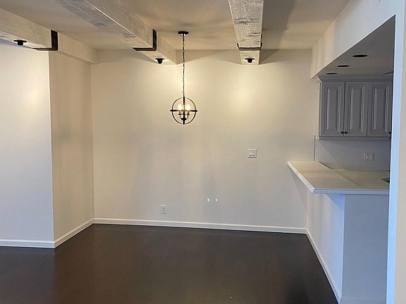 View from Living room to dining area and kitchen with bar seating