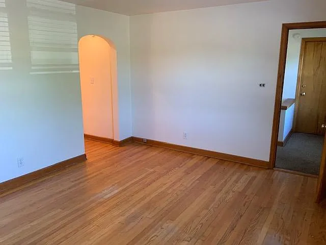 Living room looking at hallway and front door