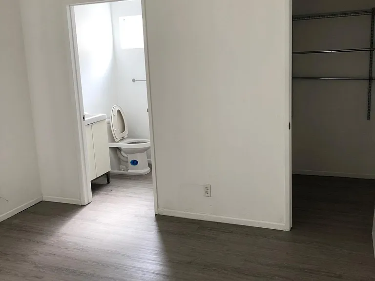 Back bedroom with view of bathroom and first closet.