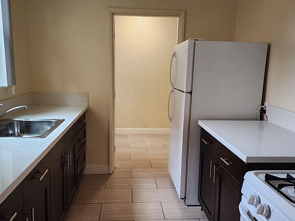 Kitchen, with bonus room visible past the refrigerator.