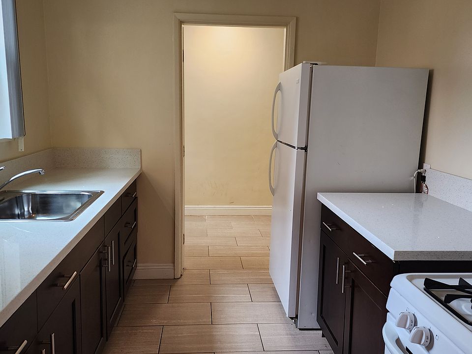 Kitchen, with bonus room visible past the refrigerator.