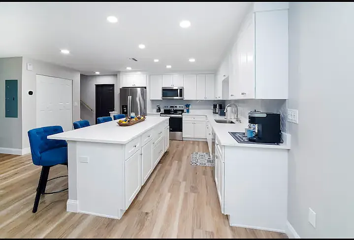 A fully stocked kitchen with stainless steel appliances, quartz countertops, and ample space for cooking together.