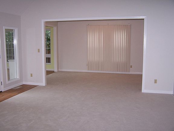 Great room photo showing access to dining room and sun porch.