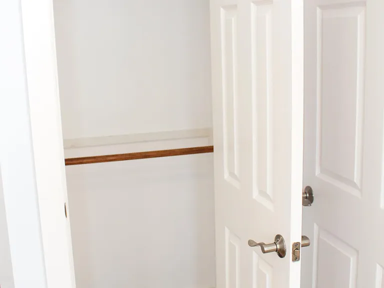 Hall closet with double-rods for your storage needs.