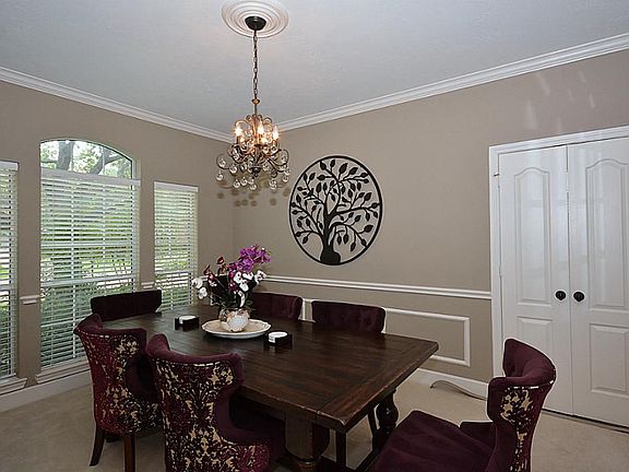 Spacious & Bright Dining filled with wall of windows, chair railing, updated lighting. Opens to the 