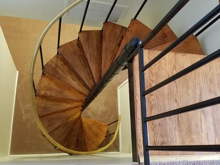 Spiral Staircase leading down stairs to 2 bedrooms, laundry area