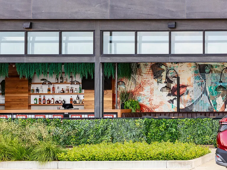 Grab a refreshing beverage and soak in the atmosphere at this vibrant local bar, just minutes from your doorstep.
