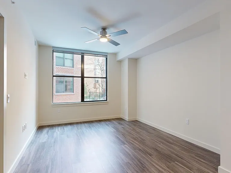 Apartment living room with wood-style flooring.