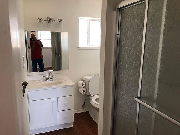 Full bath by garage door.