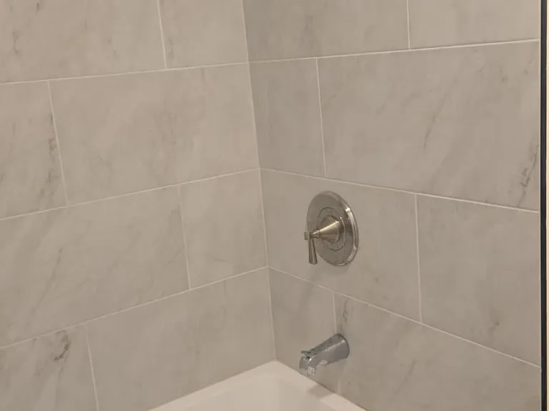 New bathtub, tiles and fixtures.