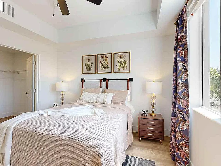 Experience the serenity of this beautifully designed bedroom, offering natural light and sophisticated decor.