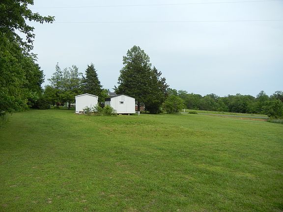 Back yard view with 2 utility buildings