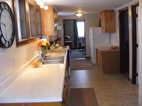 The galley-style kitchen has lots of counter space and cabinets.