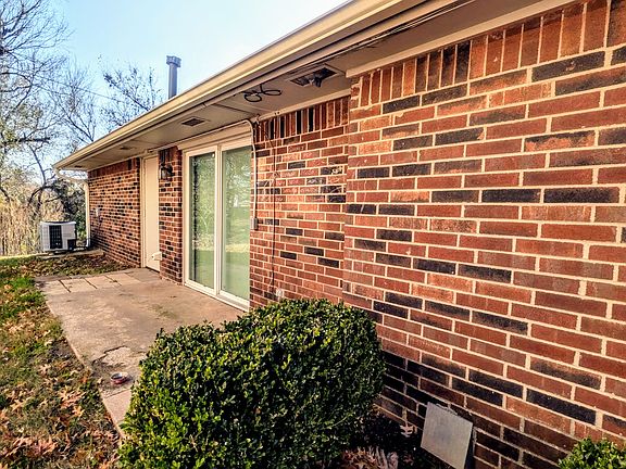 View of sliding glass door and patio on North Side of residence