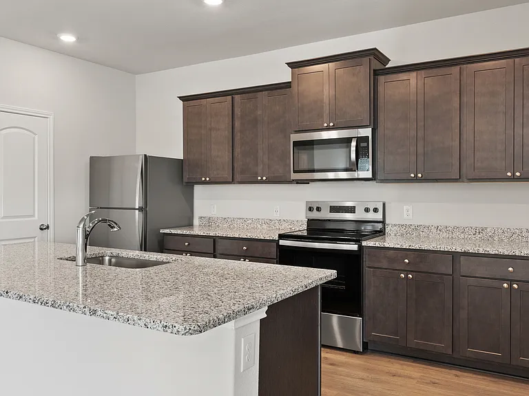 The kitchen has gorgeous wood cabinetry.