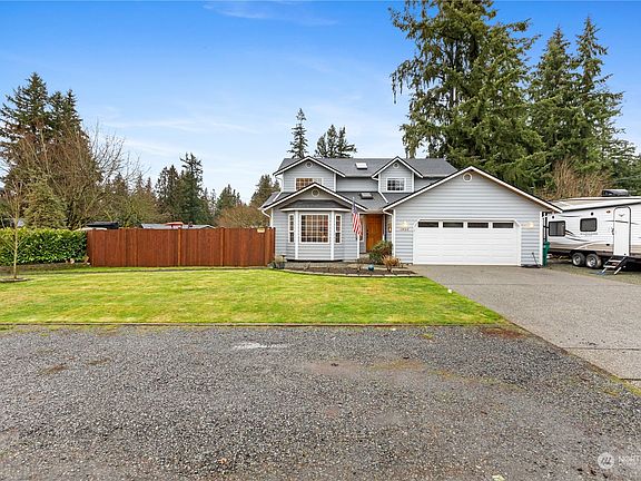 You will never be short on parking at this home!  It sits on over 10,000 sq ft. has a large driveway, additional gravel 'off street' parking in front of the home.  There is also a gravel driveway with a gate to park the things you want kept safely behind a gate on the south side of the home.  Additionally, there is RV parking on the north side of the driveway closer to a power source.>