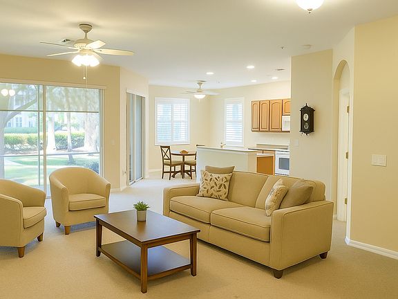 The great room has plenty of space for relaxing and a dining room while the adjacent kitchen offers additional dining and easy access for entertaining. Photo is virtually staged.