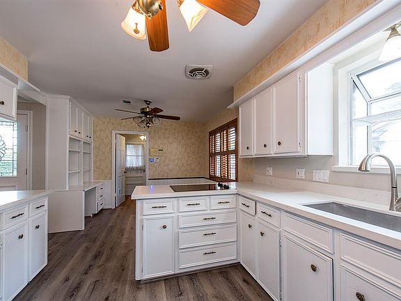 Bright kitchen with new countertops and flooring.
