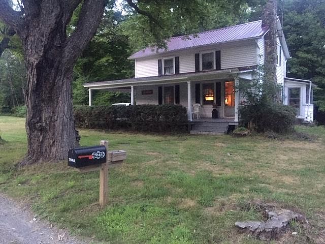 Front of home from road, shrubs have since been removed