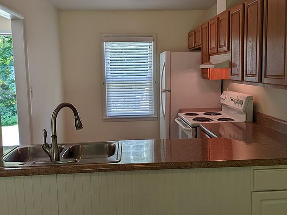 Kitchen includes refrigerator, dishwasher, range & hood.