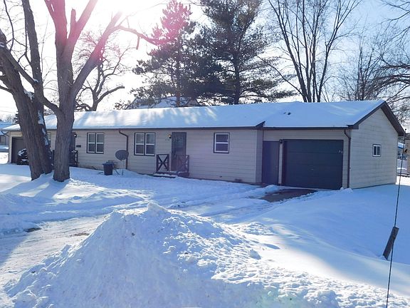 Now has new, brown garage doors and front deck!