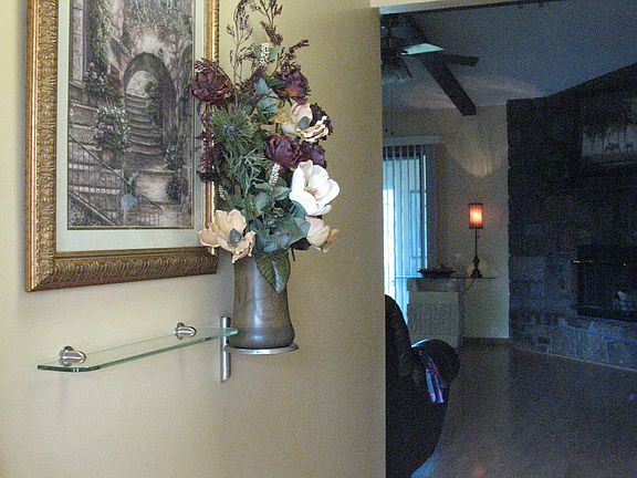 Entry hall offers a coat closet and newer lighting.