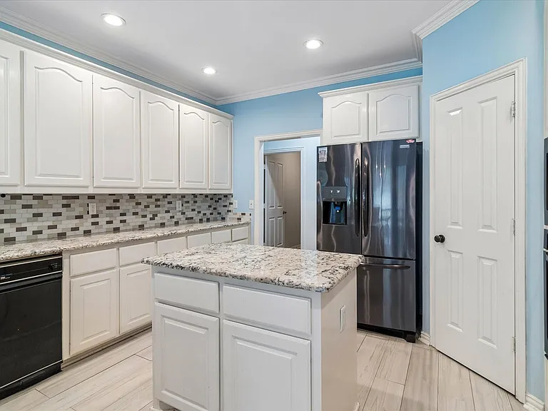 Another view of kitchen with granite counter.