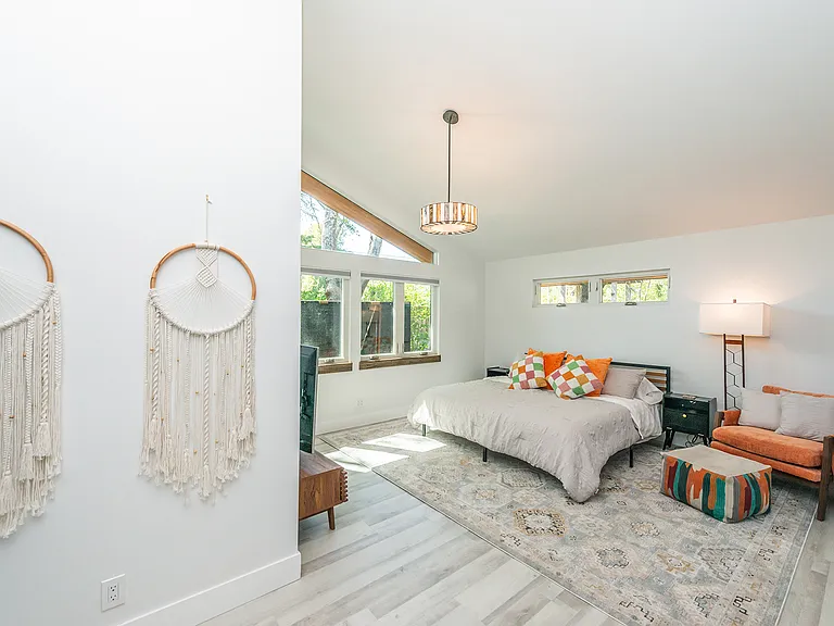 Primary bedroom with high ceilings and natural light