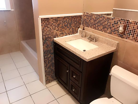 Newly painted good size bathroom. Newly tiled bathtub.