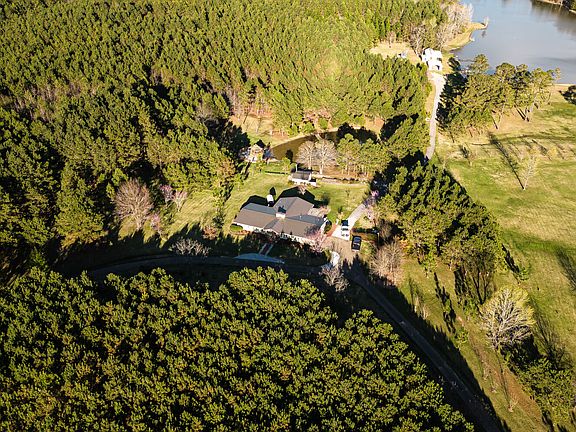 The house with the big lake and cabin behind it.