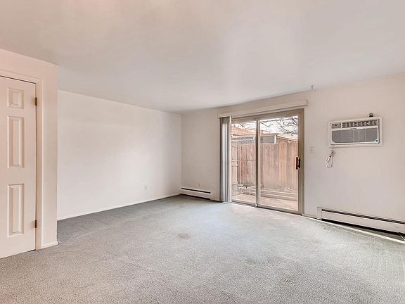 Patio off of living room and new AC unit.