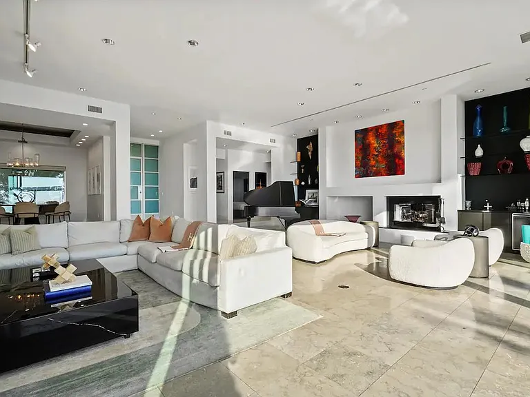 The Living Area offers plentiful seating options bathed in natural sunlight, creating a warm and inviting space for relaxation.