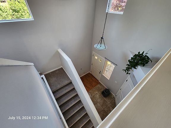 From the top of the stairs looking down to front door and garage door