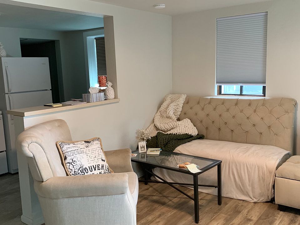 Living room and kitchen. New paint and vinyl plank flooring throughout the apartment. Shown furnished here, note that this is an unfurnished apartment.