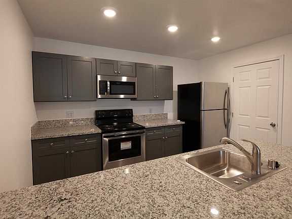 Built-in microwave, granite countertops and stainless steel appliances