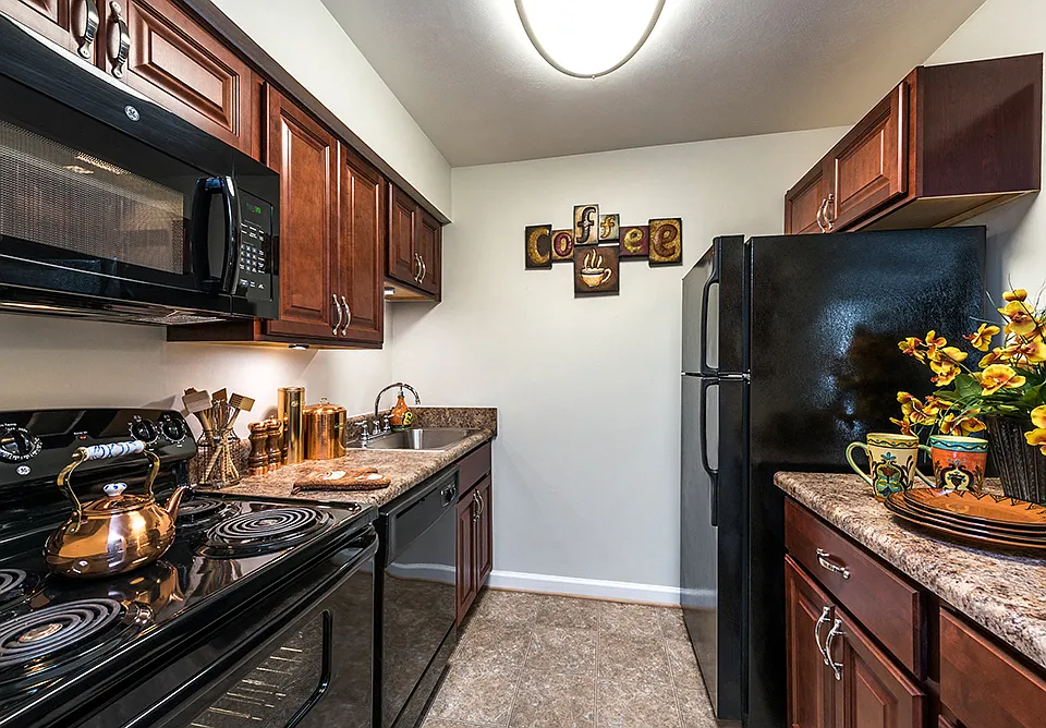 Kitchen with Cherry Cabinets in River Mews Apartments Birch Floor Plan