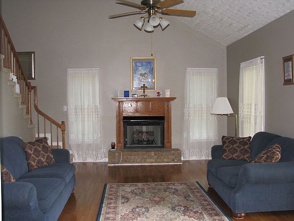 Great Room with Vaulted Ceiling,Hardwood Floors and Fireplace with Gas Logs.