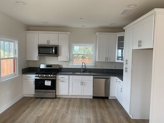 Spacious kitchen with brand new stove, oven, microwave, and dishwasher.