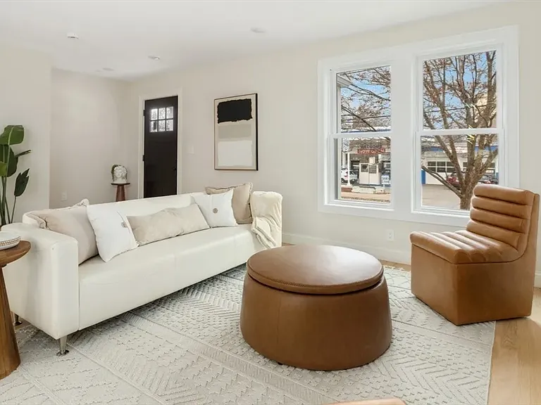 Sun-filled serenity: Oversized windows and brand-new designer flooring highlight the meticulous attention to detail in every corner.