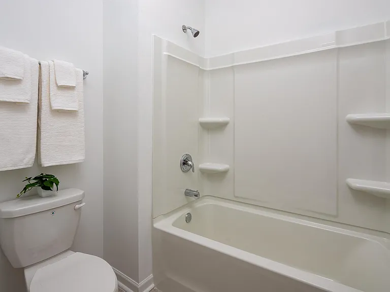 Secondary suite bathroom with a tub and shower combination