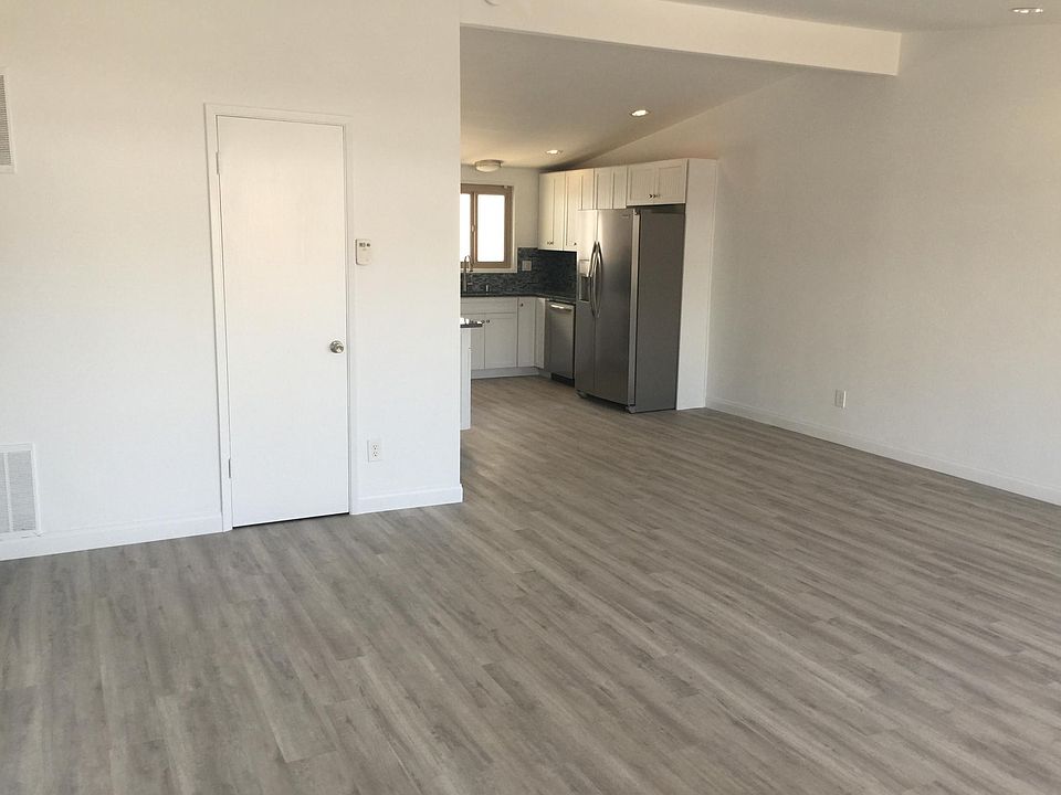 Huge entertainers living room with high ceilings and wood floors plus a guest closet