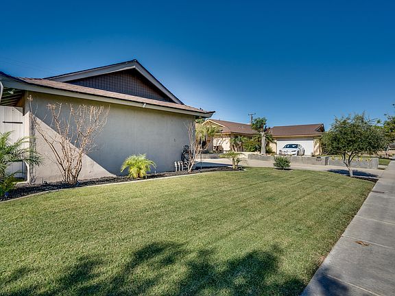 Manicured grass and straight sidewalk.