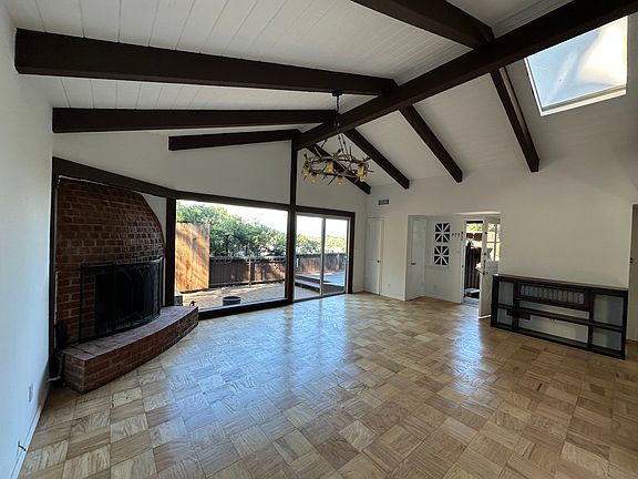Living rrom looking at fireplace and front door