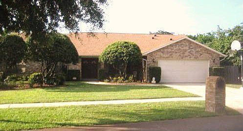 A manicured lawn and brick facade lend an elegance to the exterior 