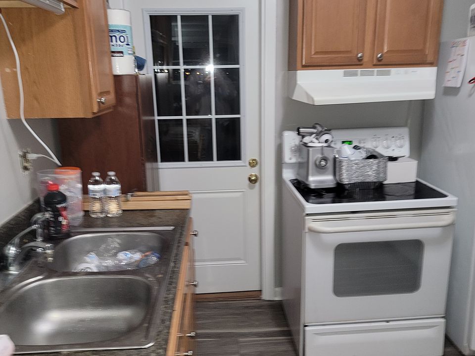 Kitchen sink and back door to private upstairs porch